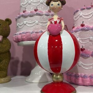 Red and White Striped Figurine with Heart